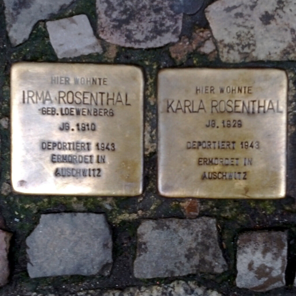 Three 'stumbling stones' ('stolpersteine') set into the sidewalk in the Mitte, in Berlin; they memorialize Jews who lived nearby until they were deported to Auschwitz and murdered.