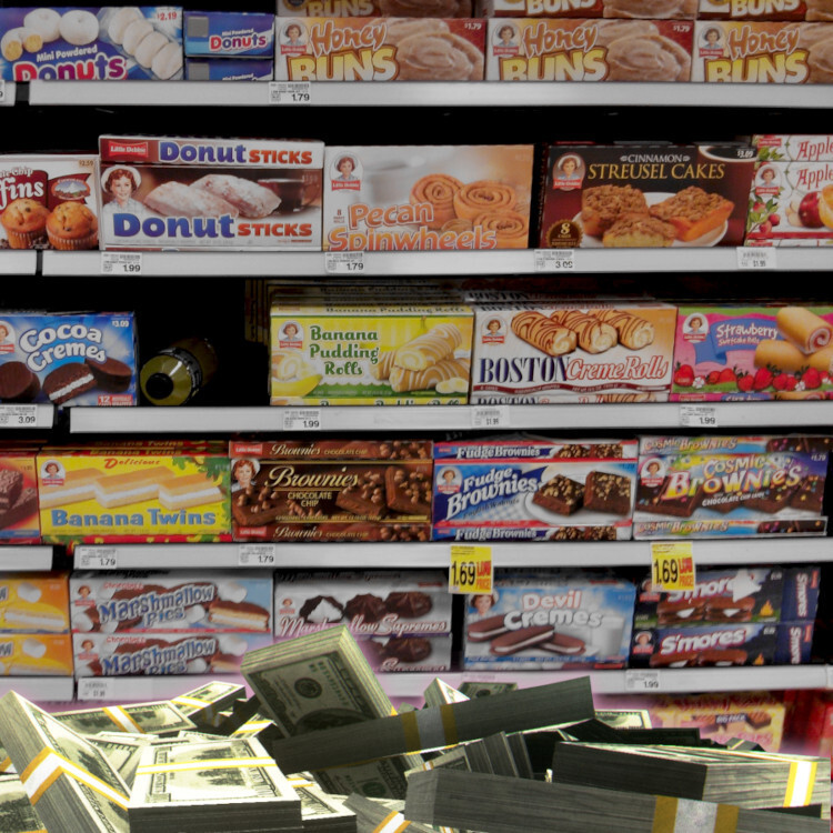 A grocery display of junk food. At its base is a pile of wrapped $100 bills.


Image:
Flying Logos (modified)
https://commons.wikimedia.org/wiki/File:Over_$1,000,000_dollars_in_USD_$100_bill_stacks.png

CC BY-SA 4.0
https://creativecommons.org/licenses/by-sa/4.0/deed.en