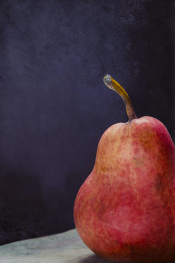 Still life photo of a Red Bartlett pear.