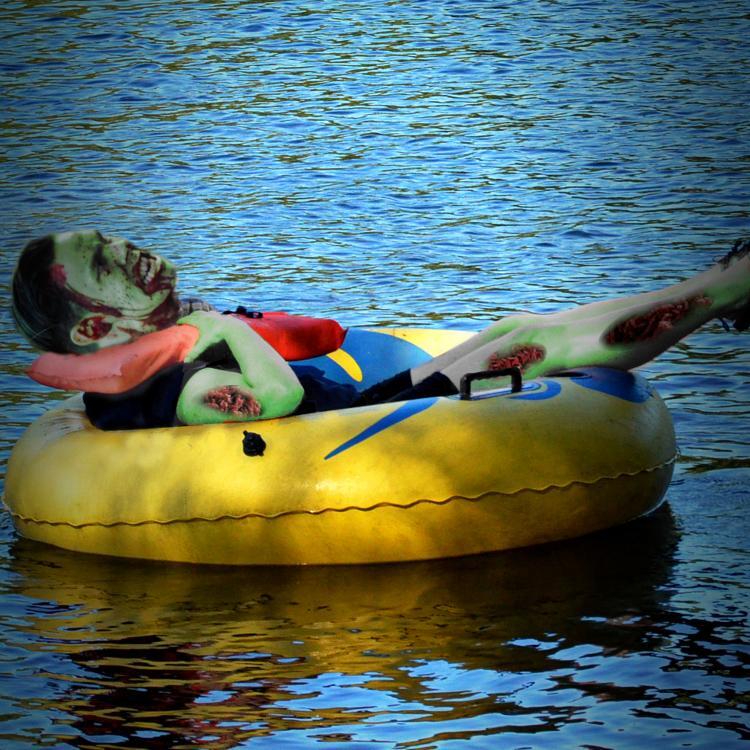 
A male figure in an inner tube, floating down a river. The figure has been altered. He now has a zombie's head, and his skin has been tinted green, with large, suppurating sores oozing out of his skin.



Image:
marsupium photography (modified)
https://commons.wikimedia.org/wiki/File:2.8_hours_later_-_Zombie_Apocalypse_(14315382305).jpg

CC BY-SA 2.0
https://creativecommons.org/licenses/by-sa/2.0/deed.en