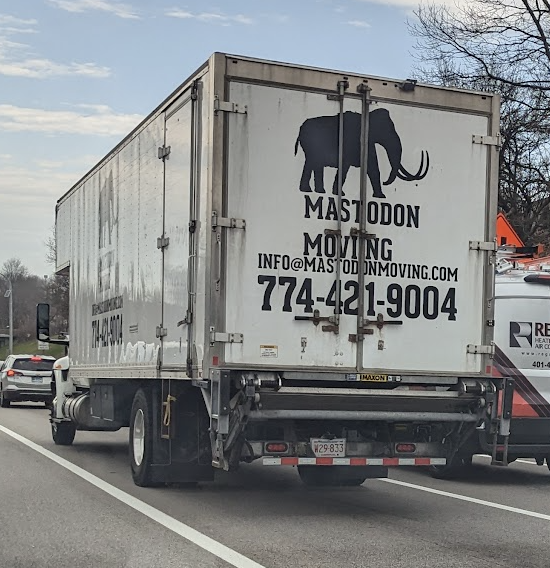 Photo of truck reading "Mastodon Moving" on a highway.