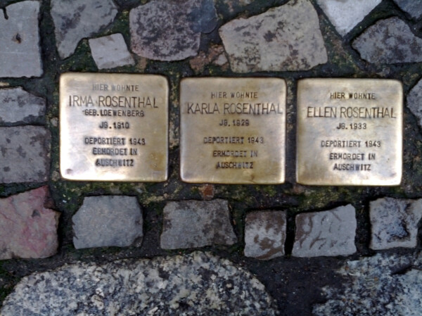 Three 'stumbling stones' ('stolpersteine') set into the sidewalk in the Mitte, in Berlin; they memorialize Jews who lived nearby until they were deported to Auschwitz and murdered.