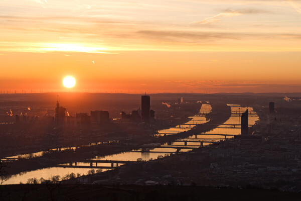 The sun rises with a red sky over Vienna